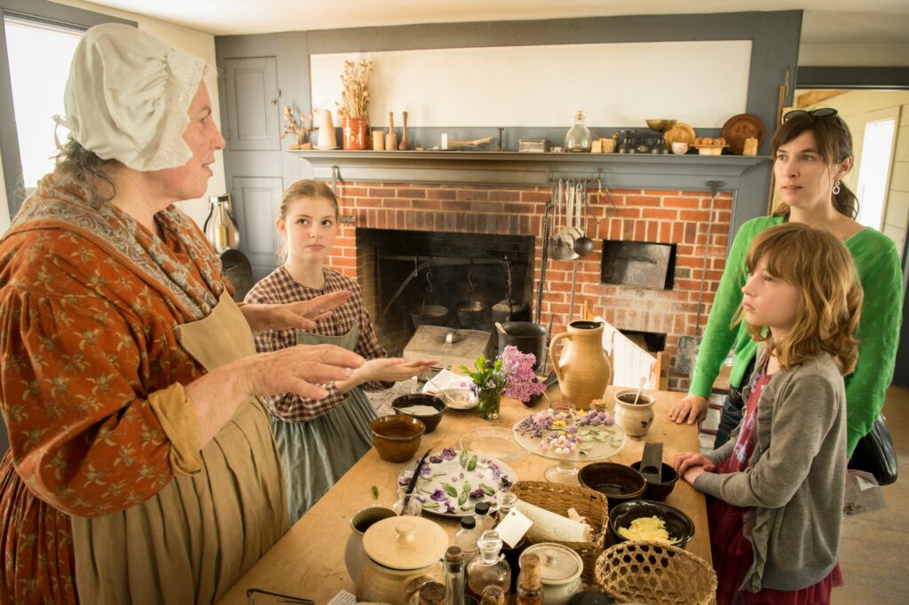 Woman in costume talking with visitors