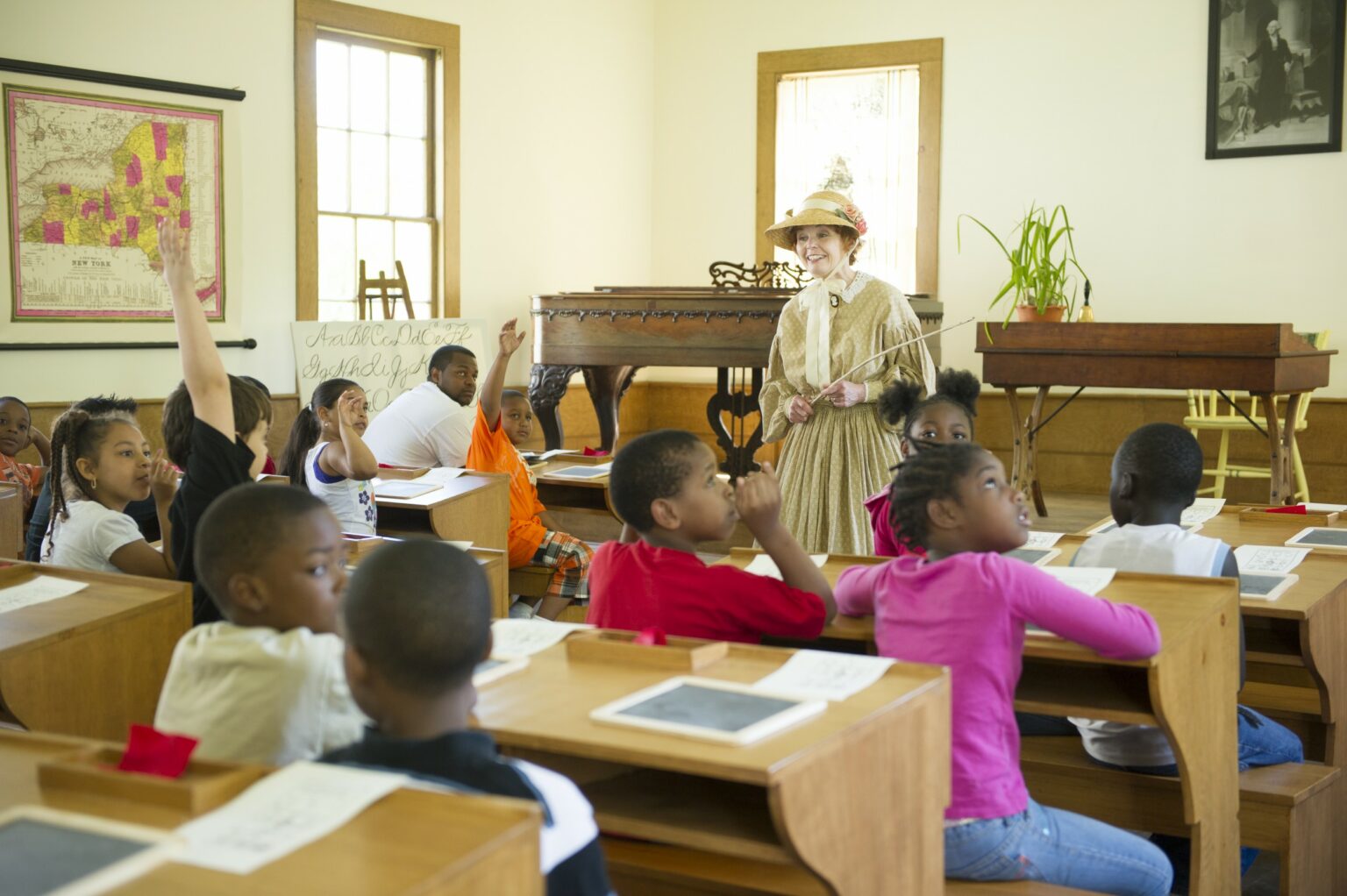 Kids sitting in one-room schoolhouse